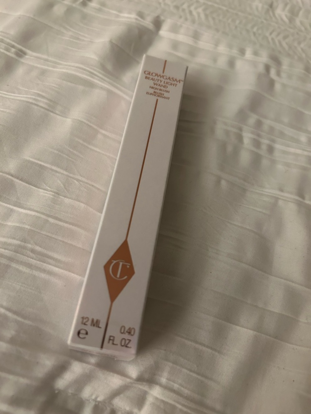 Charlotte Tilbury Glowgasm Wand in White and Gold Packaging